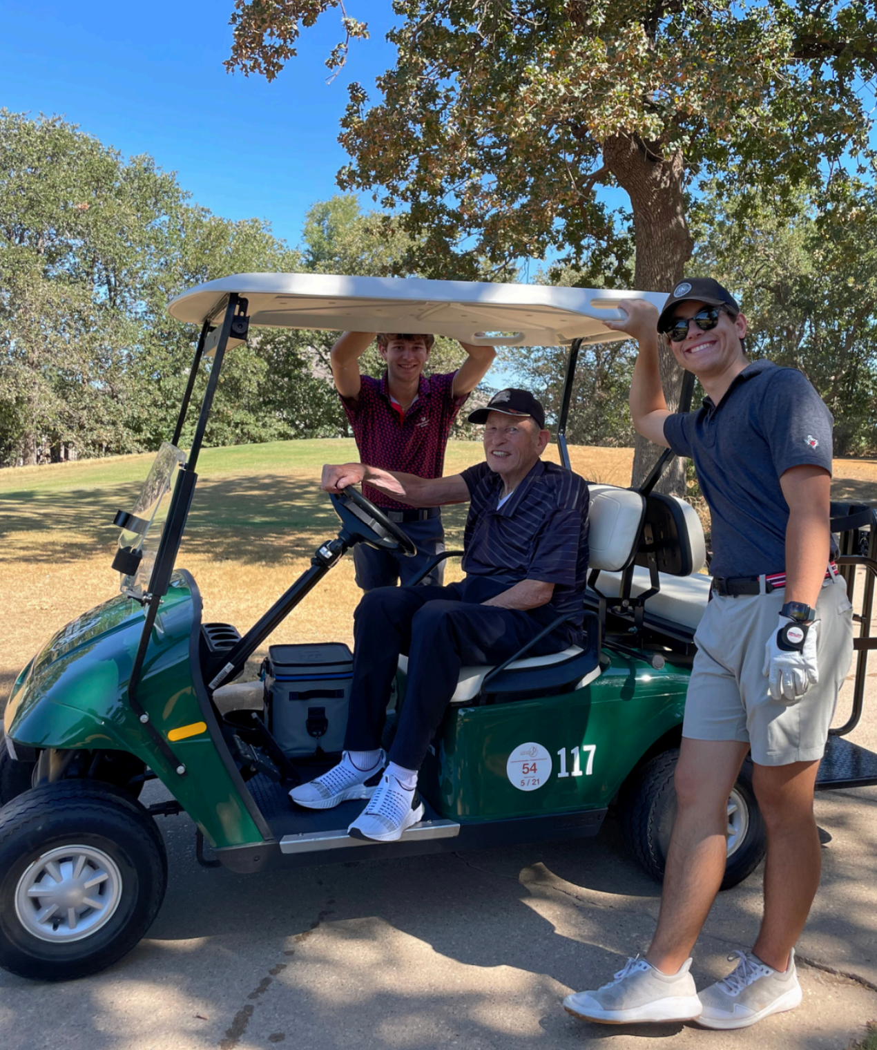 Brett Walsh and his grandfather, Dr. Roger Walker, on the golf course
